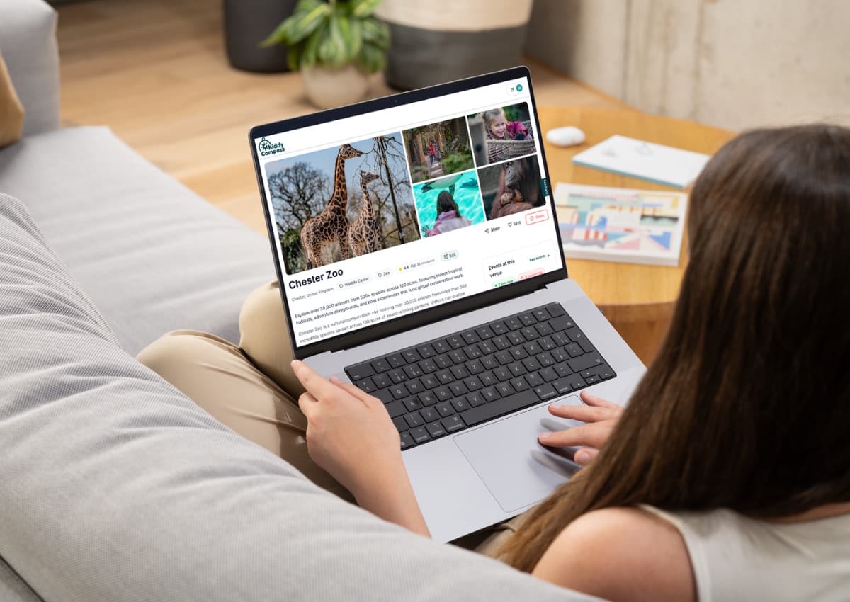 A parent browsing the Chester Zoo page on KiddyCompass on a laptop